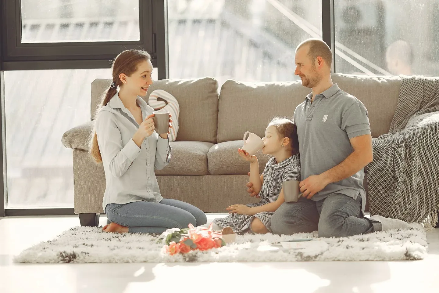 A family relaxing together in their sunlit living room